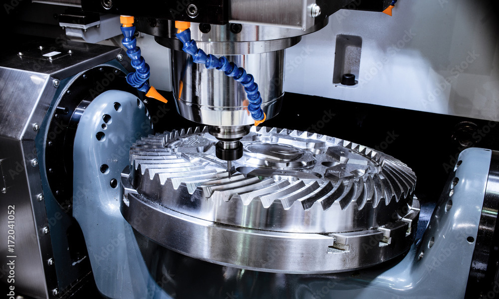 A modern CNC milling machine makes a large cogwheel.